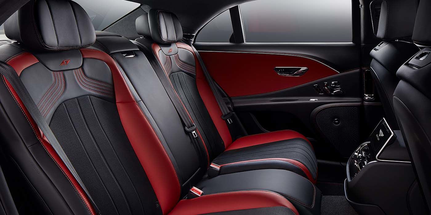Bentley Doha Bentley Flying Spur S sedan rear interior in Beluga black and Hotspur red hide with S stitching