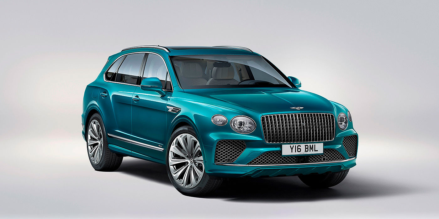 Bentley Doha Bentley Bentayga Azure front three-quarter view, featuring a fluted chrome grille with a matrix lower grille and chrome accents in Topaz blue paint.