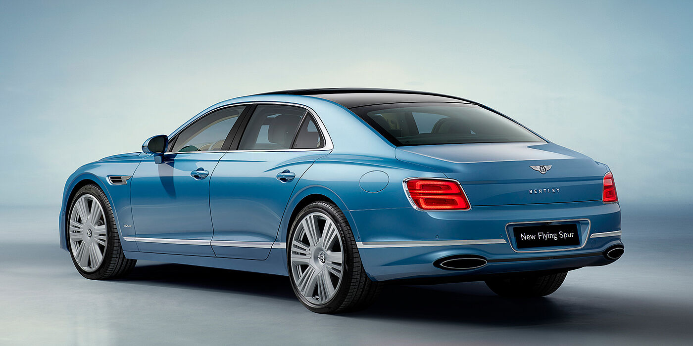 Bentley Doha New Bentley Flying Spur Azure sedan rear view in Light windsor blue by Mulliner paint with 22 inch Azure wheels and chrome exterior details