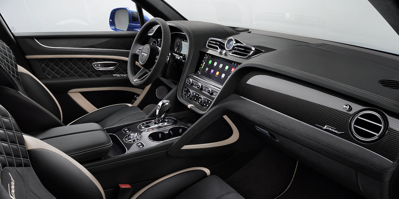 Bentley Doha Bentley Bentayga Speed SUV front interior in Beluga black and Linen hide with carbon fibre veneer