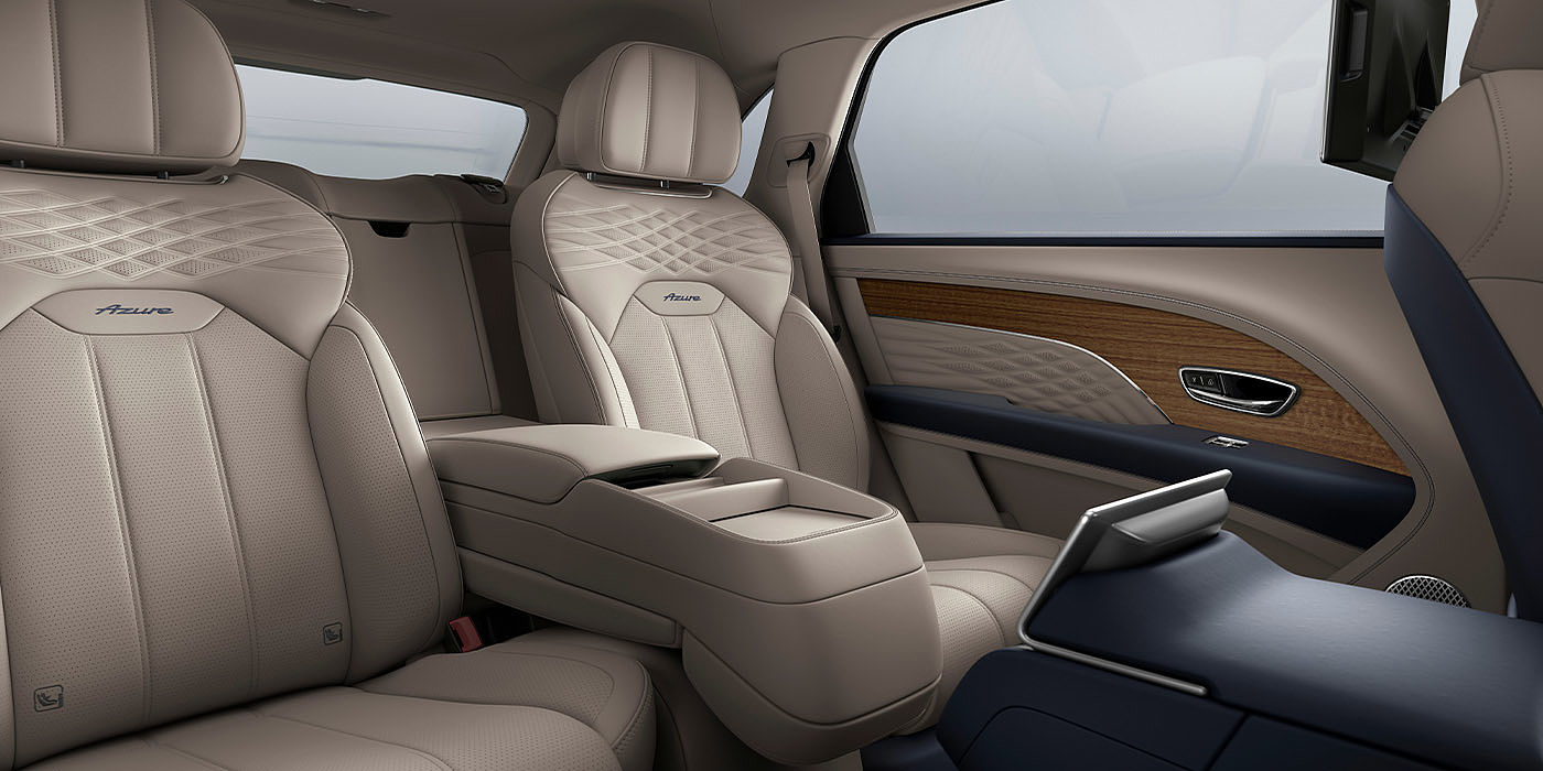 Bentley Doha Bentley Bentayga EWB Azure interior view for rear passengers with Portland hide featuring Azure Emblem in Imperial Blue contrast stitch.