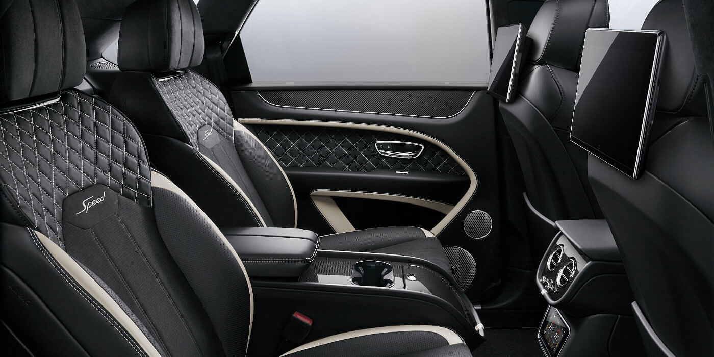 Bentley Doha Bentley Bentayga Speed SUV rear interior in Beluga black and Linen hide with carbon fibre veneer