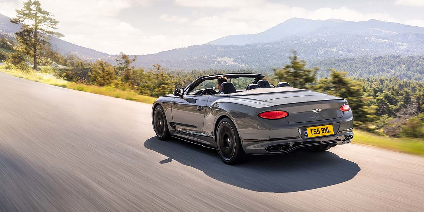 Bentley Doha Bentley Continental GTC S convertible in Cambrian Grey paint rear 34 dynamic driving