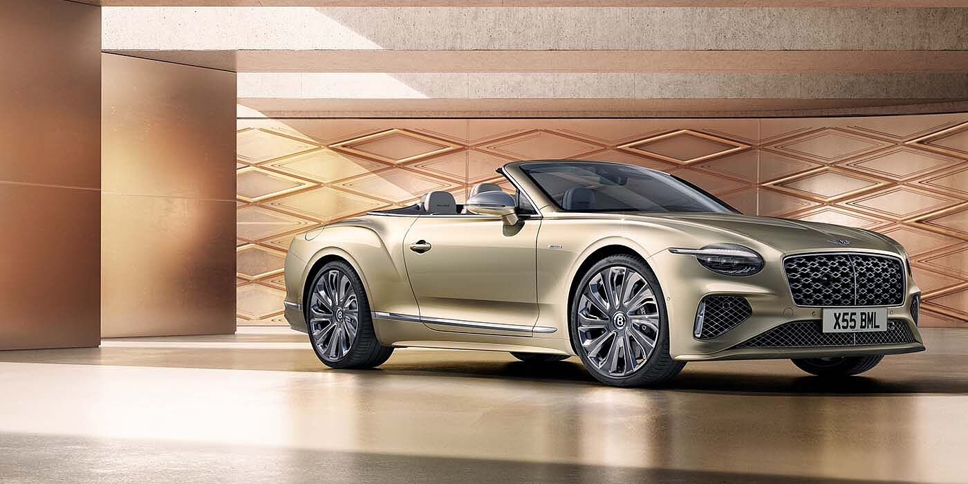 Bentley Doha Bentley New Continental GTC Mulliner V8 hybrid front three quarters in Patina paint