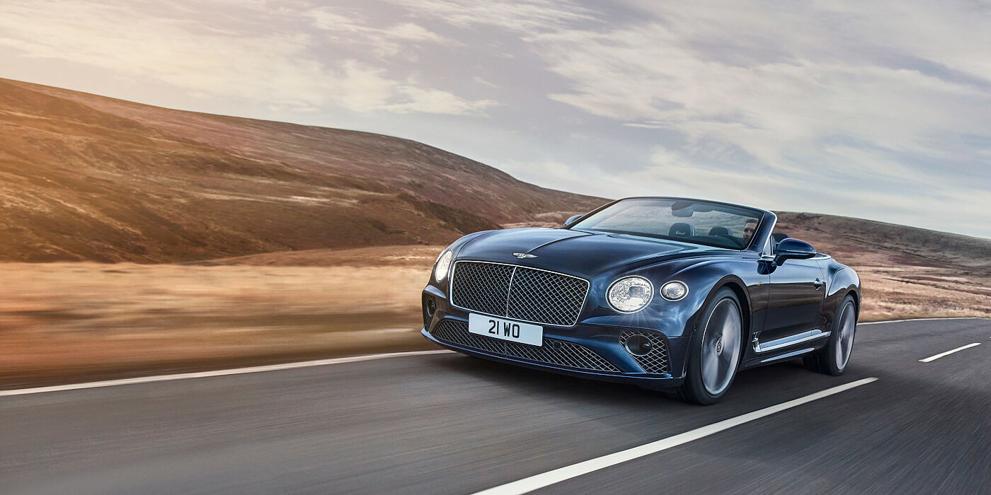 Bentley Doha Bentley Continental GTC Speed convertible in Peacock paint side front 34 dynamic