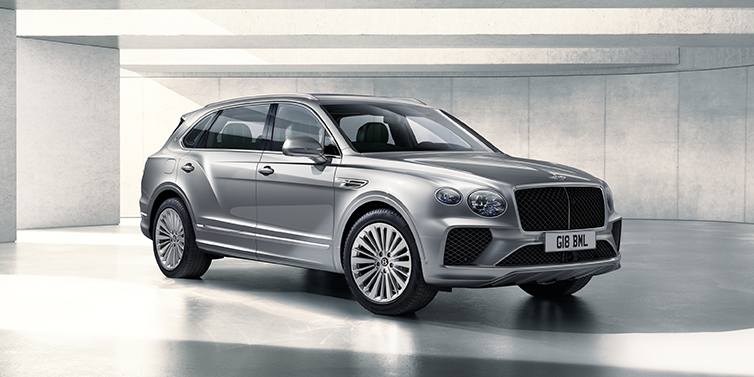 Bentley Doha Bentley Bentayga Extended Wheelbase SUV front three quarter in Moonbeam paint with a grey background